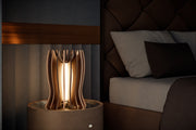 Lady Noir luxury table lamp handcrafted in Italy from anodized aluminum with metallic gold finish, linen lampshade and warm LED lighting.