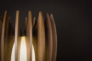 Contemporary handcrafted wooden table lamp in solid Canaletto walnut with gold lacquered stainless steel frame, linen diffuser and integrated 2700K warm LED light, entirely made in Italy.