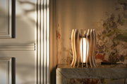 Luxury Lady Noir table lamp crafted in Italy with a Canaletto walnut structure, refined metallic gold details, premium linen lampshade and warm LED light.