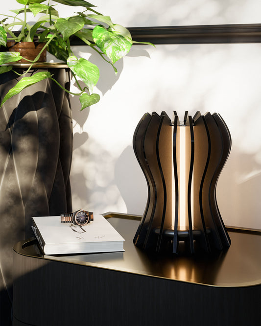 Casper black walnut table lamp with slatted design and warm LED light, in a modern bedroom