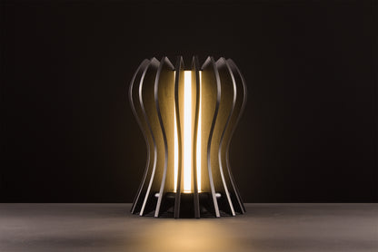 Casper table lamp in natural oak, handcrafted Italian design, sculptural minimal design, refined elegance, warm light, studio black background.