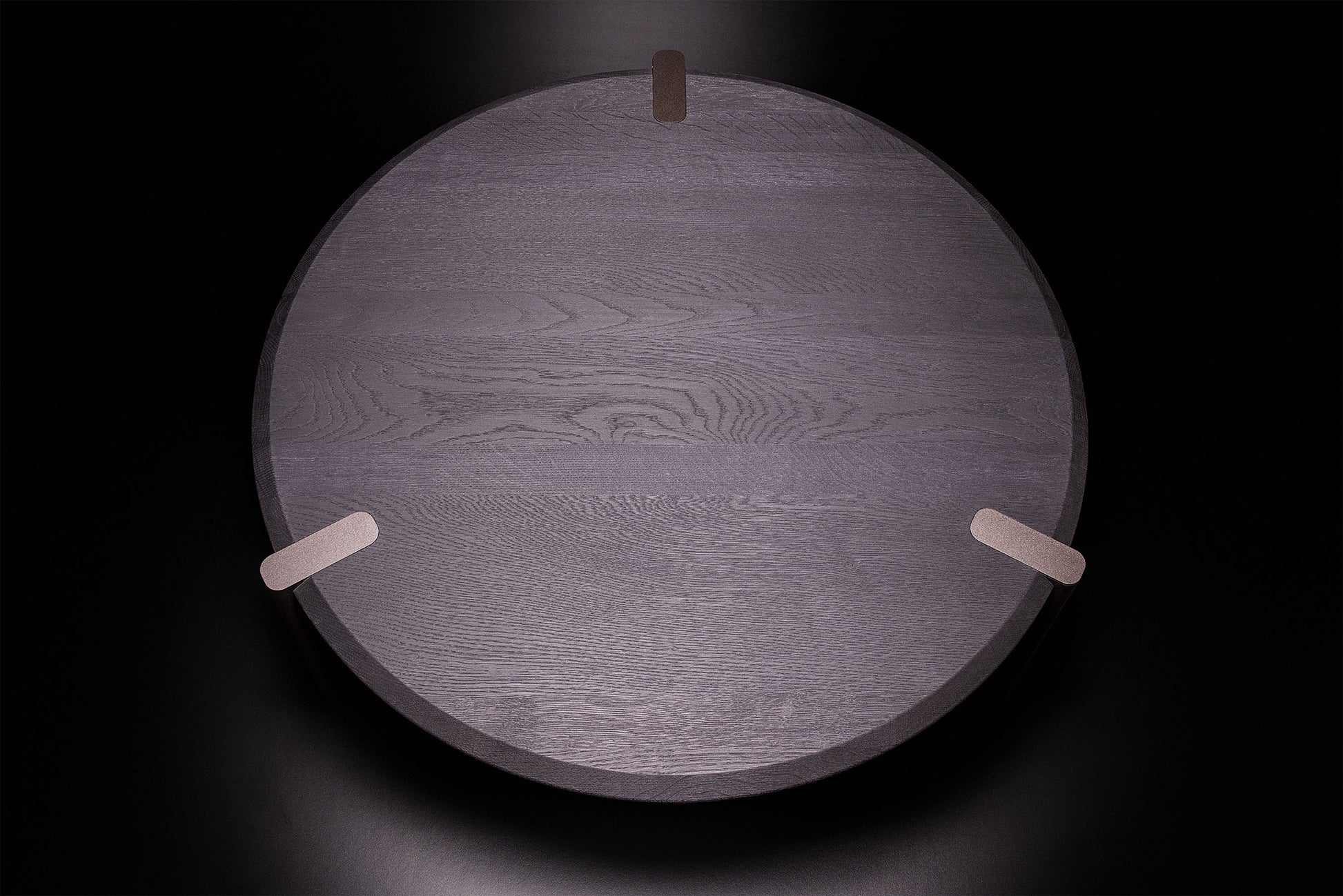 Luxury Edones round coffee table in black oak, minimal Italian design, handcrafted with bronze textured legs and attention to detail. By Vera Forma.