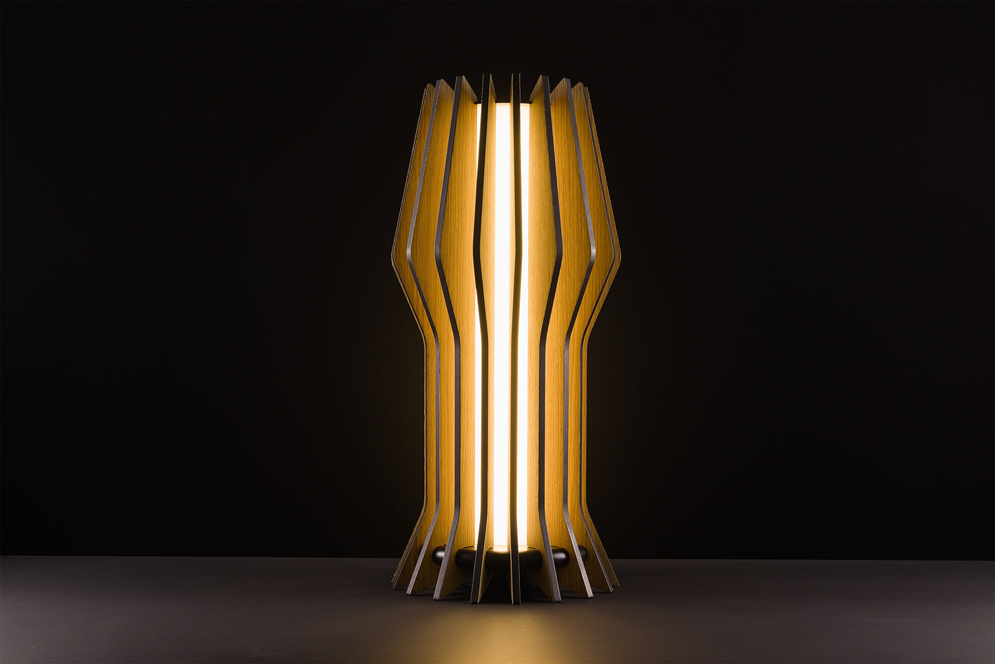 Futura table lamp in natural oak, handcrafted Italian design, sculptural minimal style, vintage elegance, warm light, studio black background.