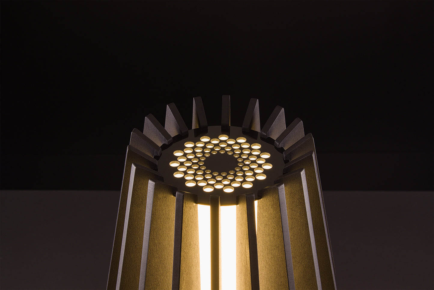 Handcrafted Futura lamp in dark stained walnut, Italian luxury lighting, soft warm LED glow, studio black backdrop.