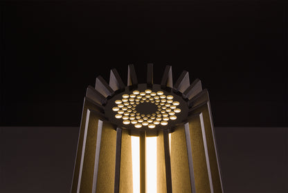 Handcrafted Futura lamp in dark stained walnut, Italian luxury lighting, soft warm LED glow, studio black backdrop.