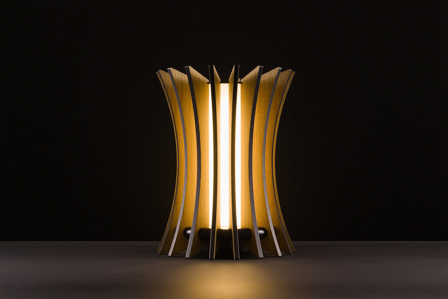 Handmade Gothica lamp in natural oak, Italian luxury design, soft warm LED glow, photographed on black background