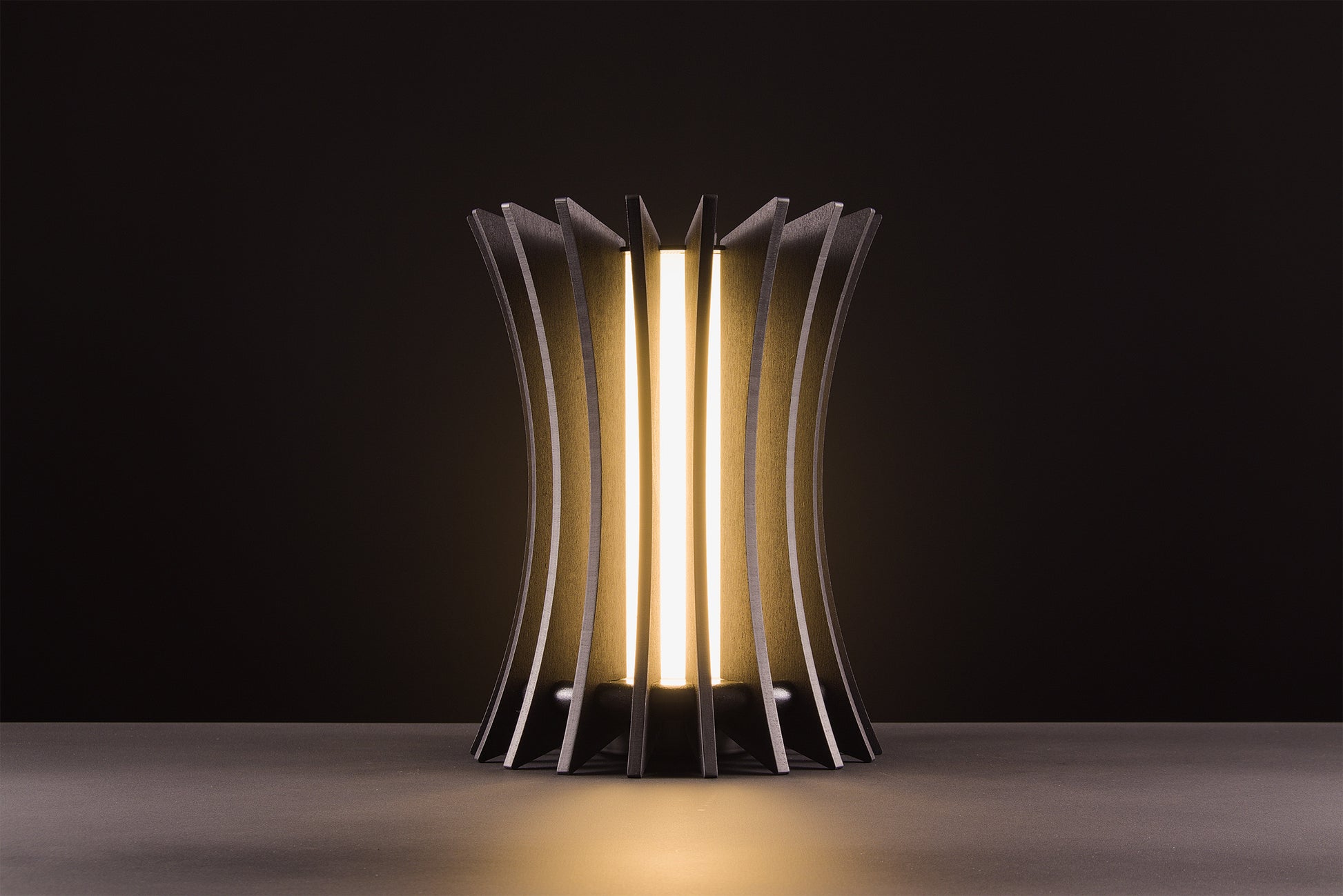 Gothica table lamp in natural oak veneer, handcrafted Italian design, warm light, luxury material product on black studio background.