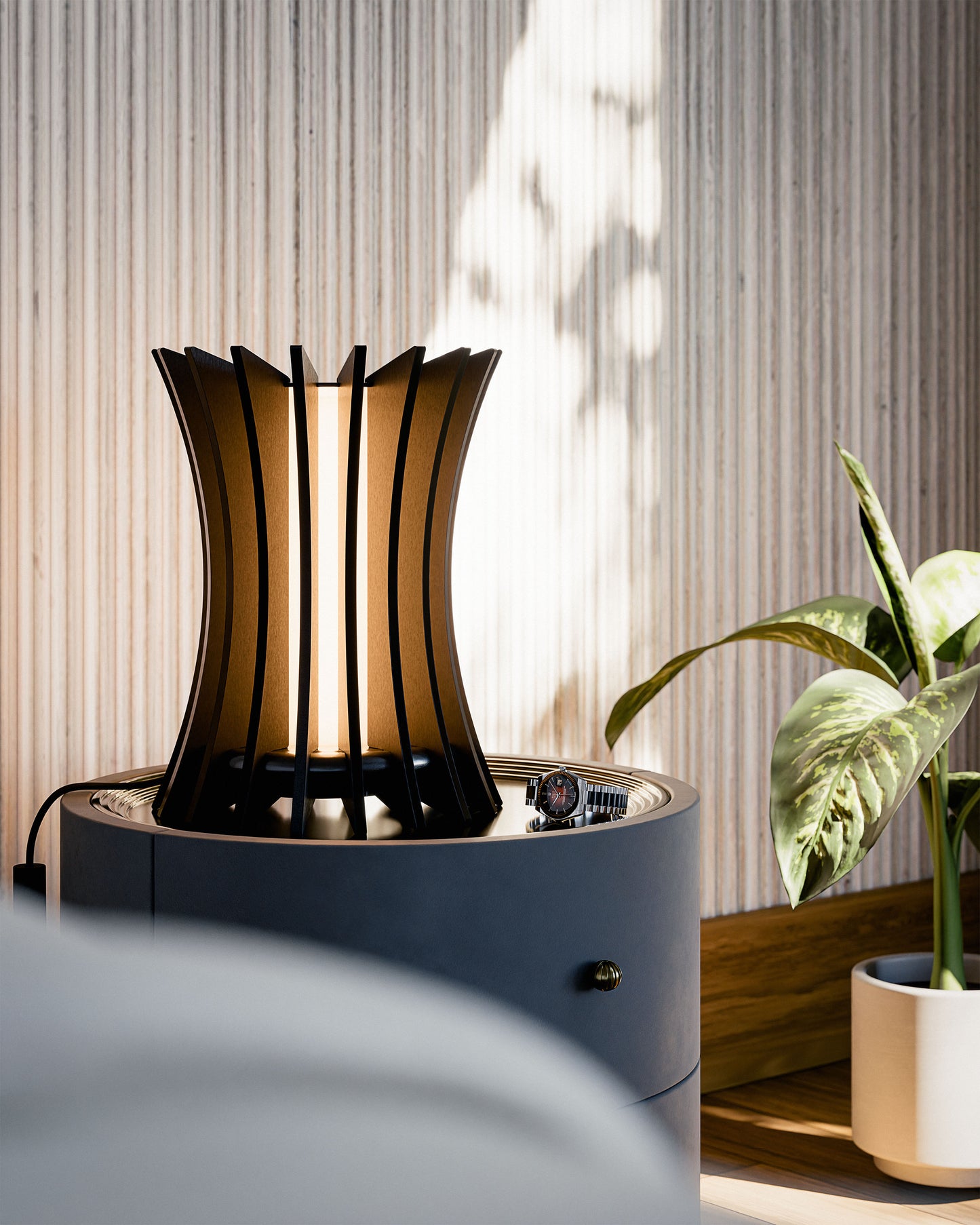 Gothica table lamp in black walnut veneered wood sculptural modern design, placed in a minimalist modern bedroom. Warm led light.