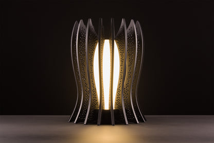 Lady Noir lamp in dark stained walnut, Italian handcrafted luxury design, warm 2700K LED, photographed on black studio background.