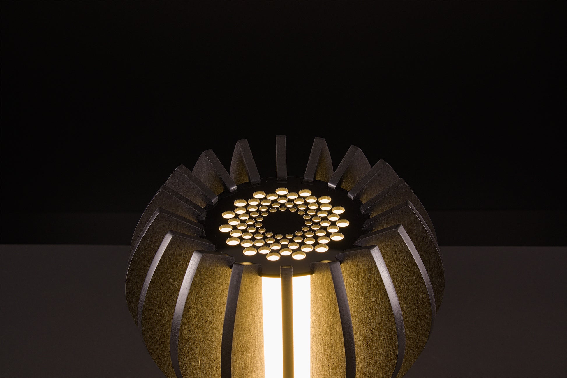 Handcrafted Futura lamp in dark stained walnut, Italian luxury lighting, soft warm LED glow, studio black backdrop.