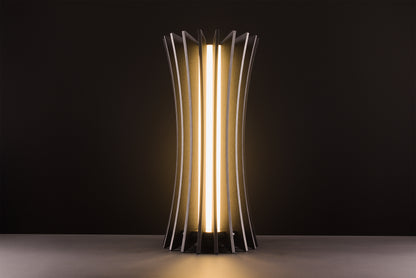 Vertigo table lamp in dark stained walnut, handcrafted Italian design, sculptural minimal style, refined elegance, warm light, studio black background.