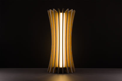 Vertigo table lamp in natural oak, handcrafted Italian luxury design, warm 2700K LED, photographed in studio on black background.