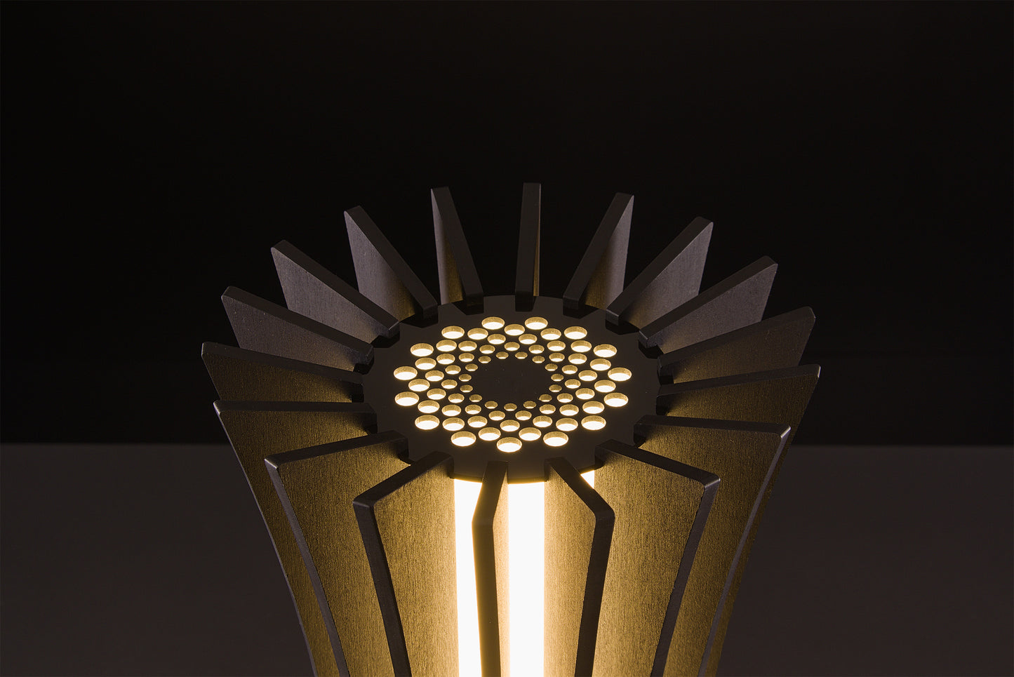 Luxury Vertigo lamp in dark walnut, Italian handmade craftsmanship, soft warm LED light, photographed on black studio backdrop.