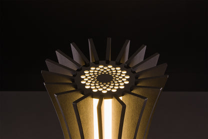 Luxury Vertigo lamp in dark walnut, Italian handmade craftsmanship, soft warm LED light, photographed on black studio backdrop.